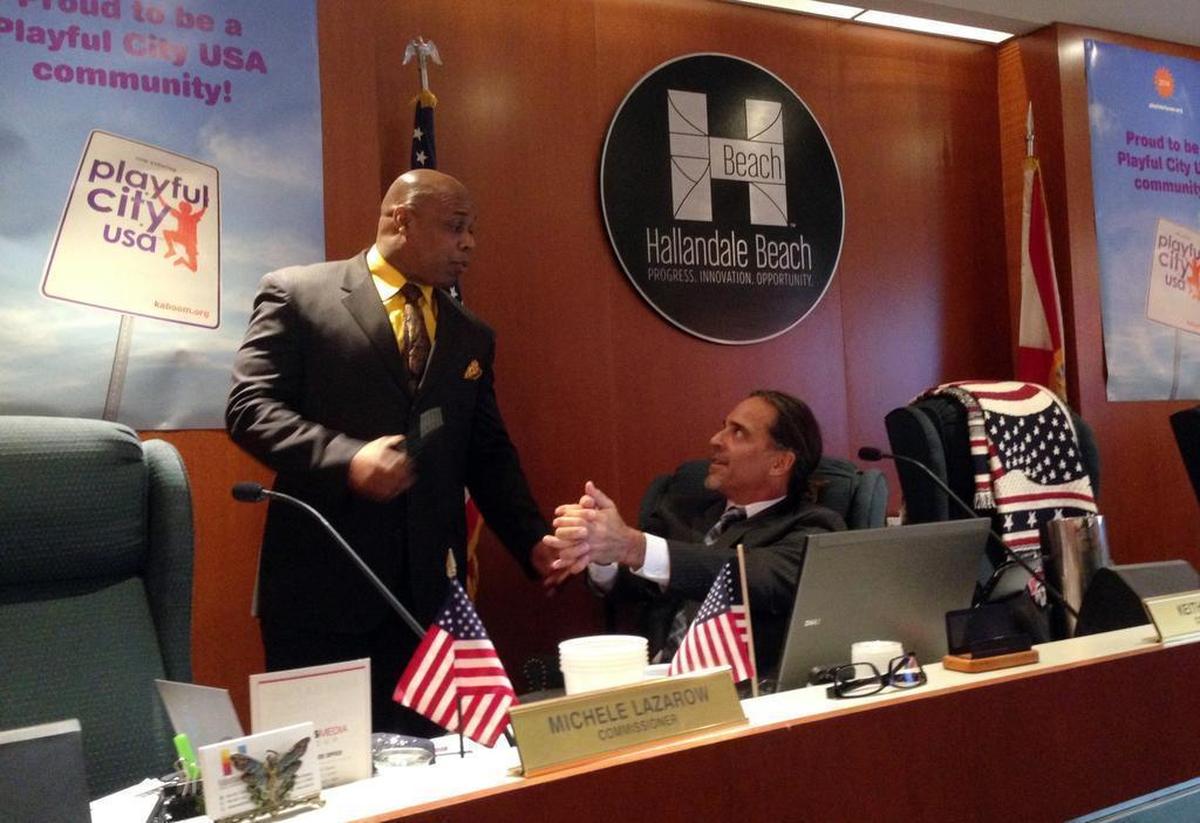Commissioner Keith London, seated, asks Police Chief Dwayne Flournoy whether he is going to put cuffs on him during a commission meeting on Jan. 12, 2015. Mayor Joy Cooper had asked that London be removed for being disruptive. In the end, he stayed.