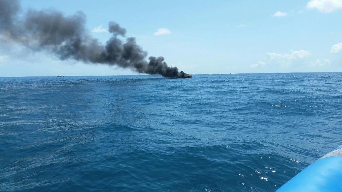 Long view of the Saturday morning boat fire about four miles off Key Biscayne