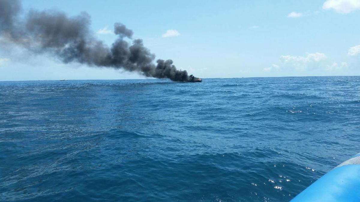 Long view of the Saturday morning boat fire about four miles off Key Biscayne