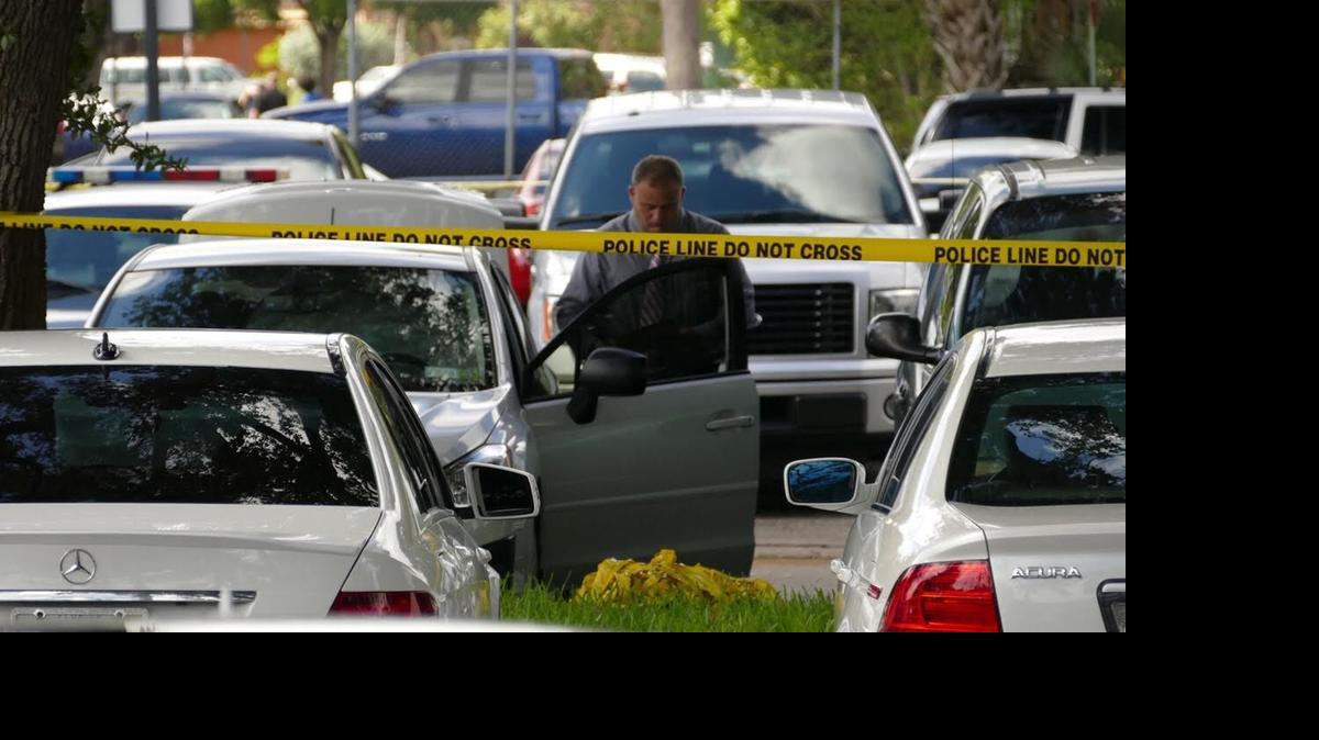
A detective looks over a car in which a man was found stabbed at the Hollywood Police Department.
