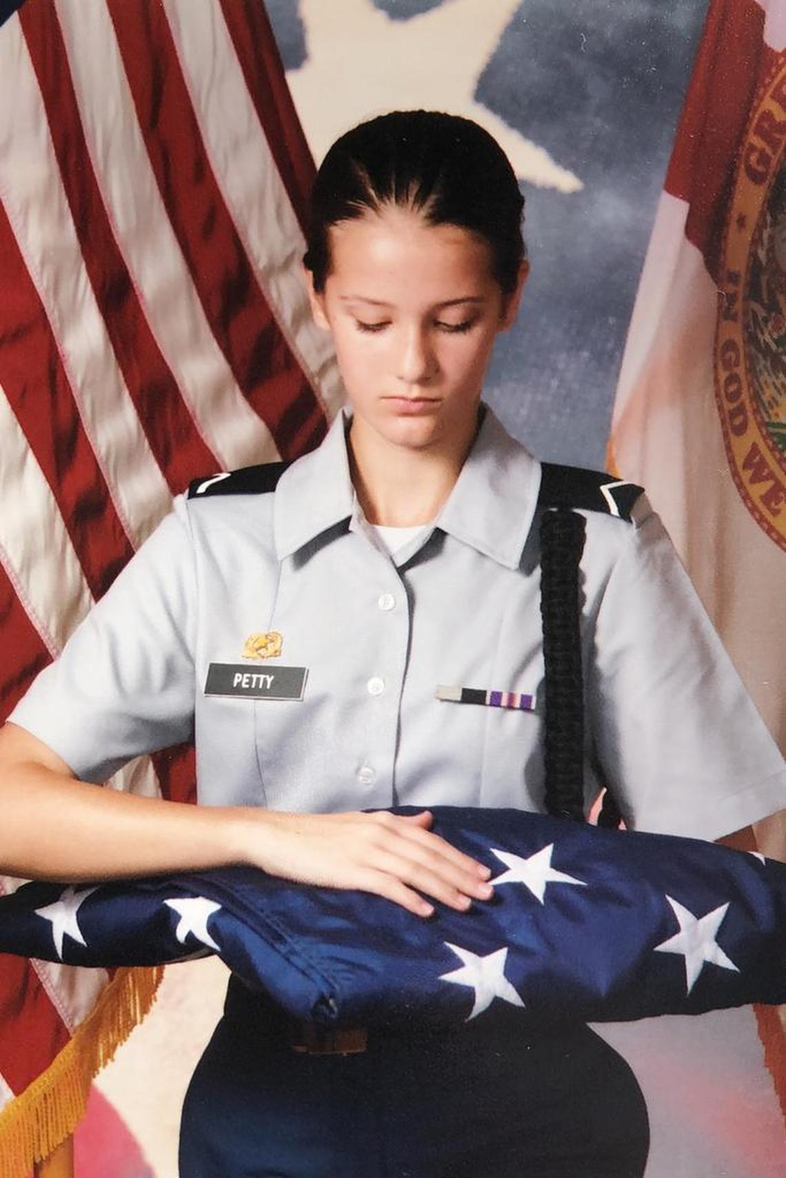 Alaina Petty, 14, poses with the American flag in her U.S. Army Junior Reserve Officers' Training Corps uniform.