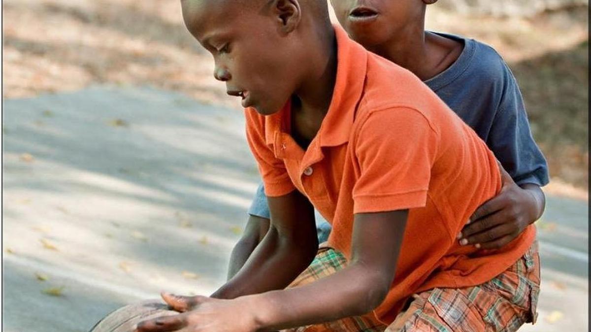 Two boys from the Destiny Village orphanage in Pierre Payen, Haiti, play with one of the 300 basketballs that Hoop for Haiti sent to the home. Alexis Murphy, a senior guard on the women’s basketball team at Nova Southeastern University, founded the nonprofit.