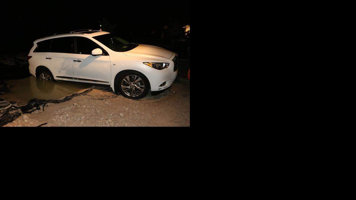 
Part of an SUV went underwater in Weston after a main break.
