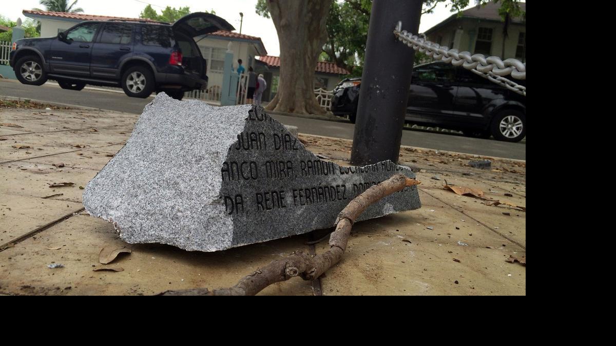 
A piece of a shattered stone sits near a monument erected years ago in honor of Cuban political prisoners, which was destroyed after a vehicle smashed into it. The monument site is in front of a house at 1140 SW 13th Ave. devoted to the cause of political prisoners. 
