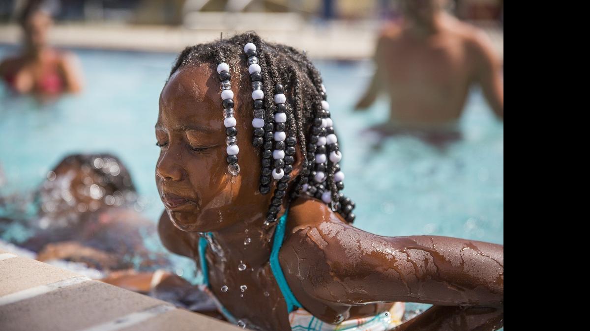 
Shanylah Johnson, 6, emerges from the pool during a swim lesson at Central Broward Regional Park’sTropical Splash Water Park in Lauderhill on Tuesday, June 30, 2015. Around 1,500 Broward County children will receive free swim lessons thanks to an anonymous donor who gave the Broward Sheriff’s Office a $70,000 donation.
