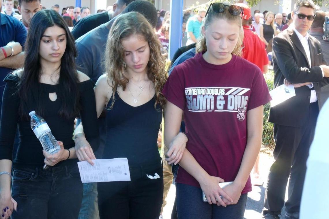 Three young girls participate in a vigil at Parkridge Baptist Church on Thursday, Feb. 15, 2018, for the victims of the shooting at Marjory Stoneman Douglas High School.