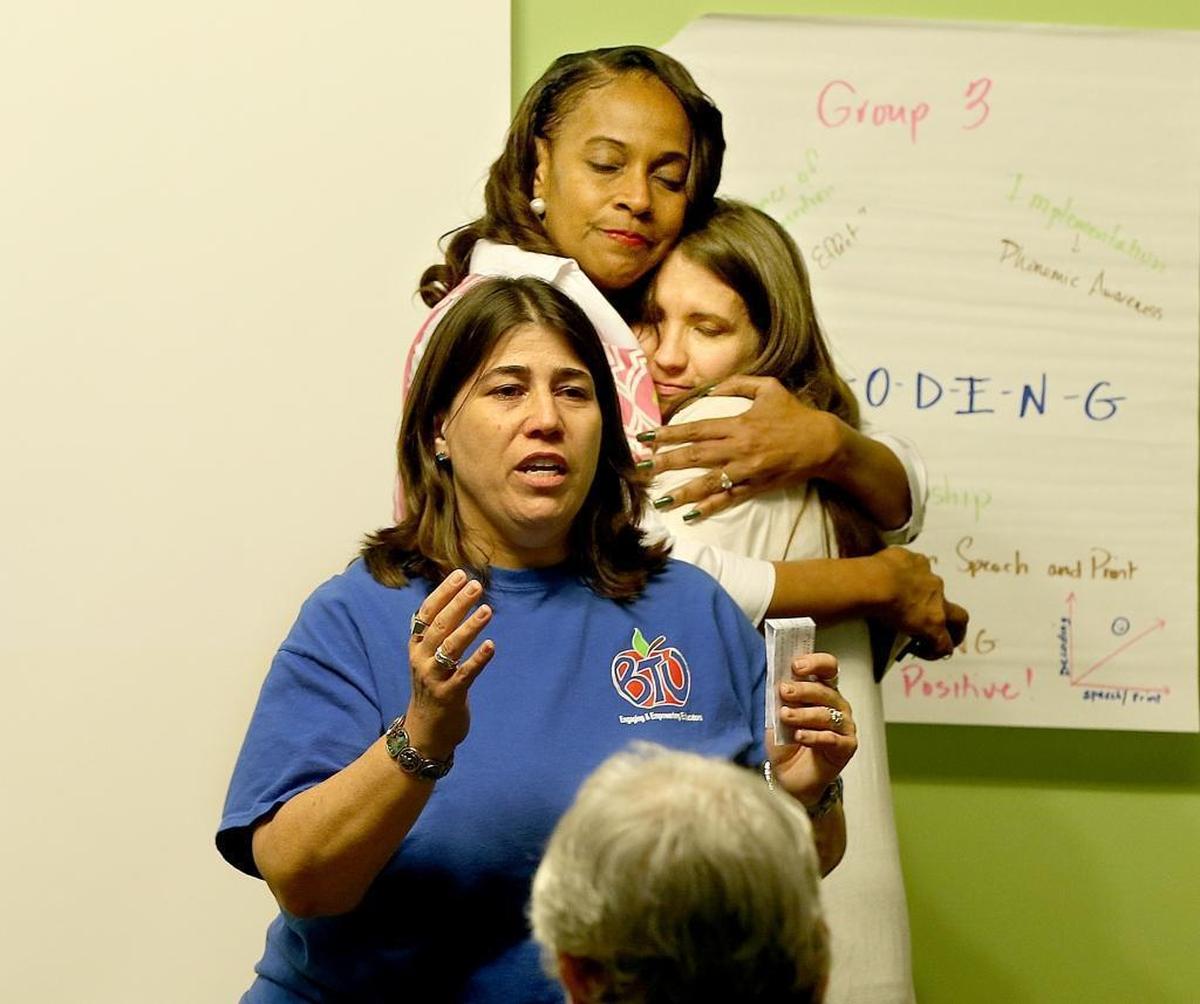 Anna Fusco, president of the Broward Teachers Union, speaks at an event held in the wake of the Marjory Stoneman Douglas High shooting. In back, Dr. Rosalind Osgood, Broward School board member, left, and Crystal Miller, Columbine shooting survivor, gave each other a hug.
