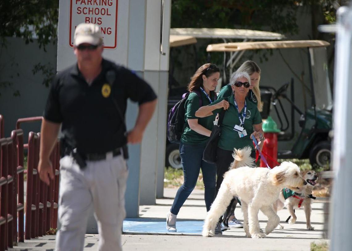 Therapy dogs visit Marjory Stoneman Douglas High School on Sun., Feb. 25, 2018, for an open house as parents and students return to the school for the first time since the shooting.