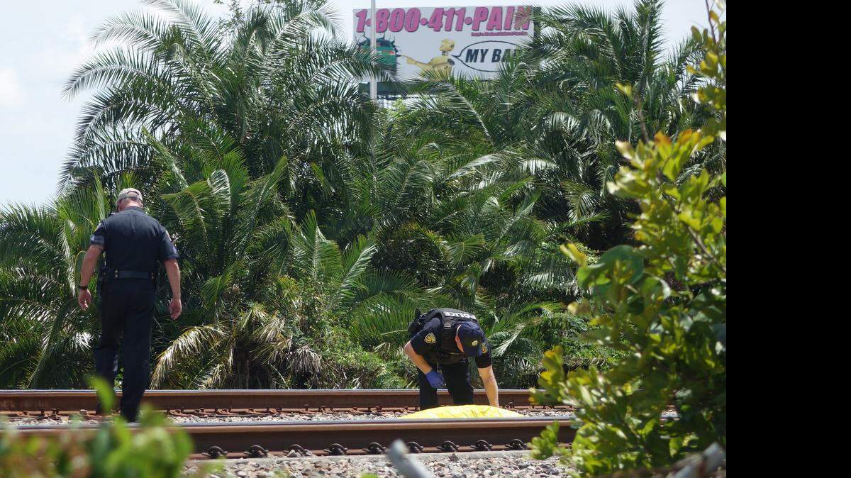 
Fort Lauderdale Police investigate the scene of a fatal crash between a Tri-Rail train and a pedestrian on Sunday, April 19, 2015, at Northwest 23rd Street. 
