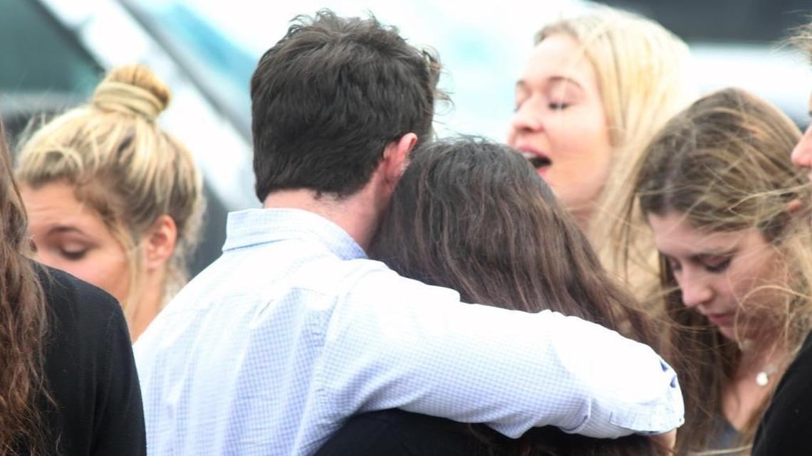 A group of students embrace each other after the religious services for Carmen Schentrup at St. Andrew Catholic Church in Coral Springs on Tuesday, Feb. 20, 2018.