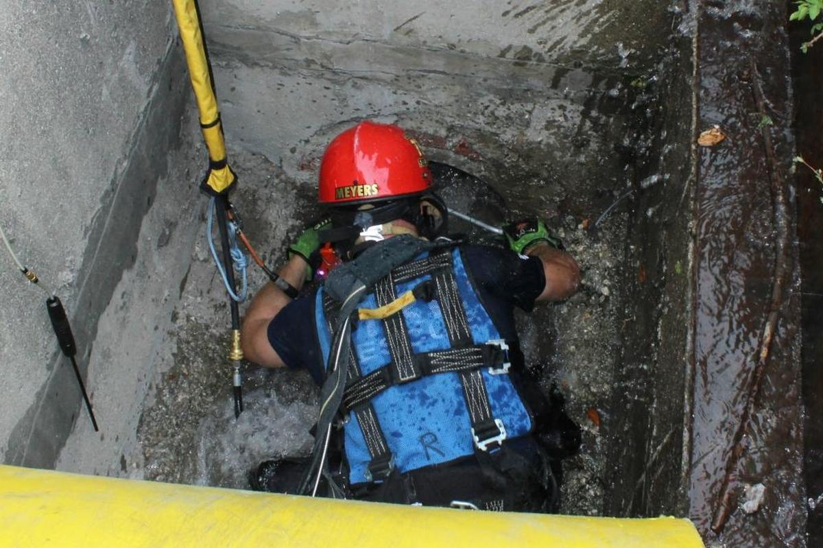 Broward Sheriff Fire Rescue Technical Rescue team Capt. Kevin Meyers uses a net in a 16-inch storm drain to try to catch a kitten that was trapped.