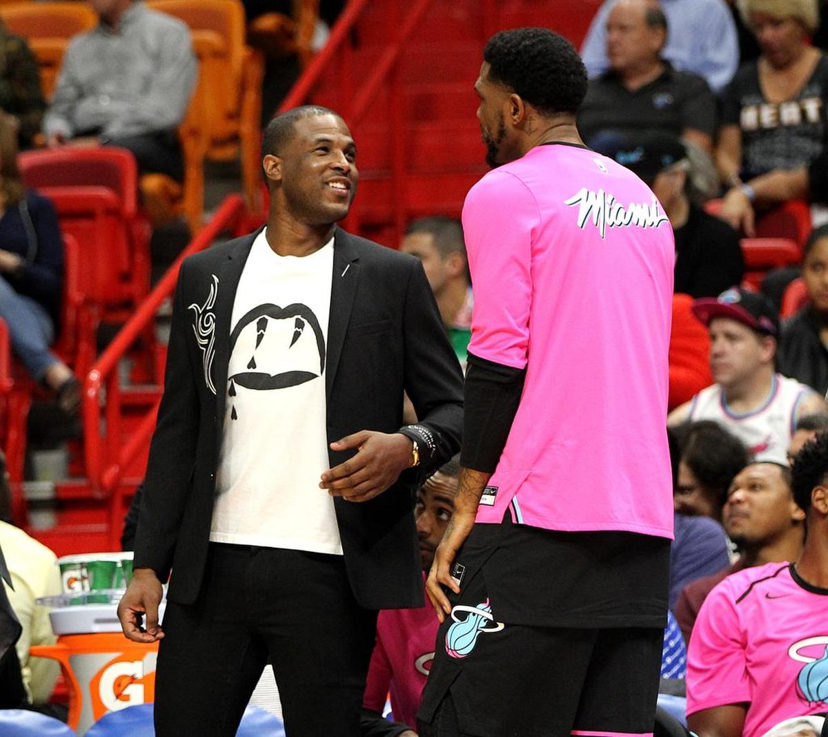 Heat guard Dion Waiters (left) talks with forward Udonis Haslem, at the bench during a time out in the second quarter of the Miami Heat vs Houston Rockets at AmericanAirlines Arena in Miami on Thursday, December 20, 2018.