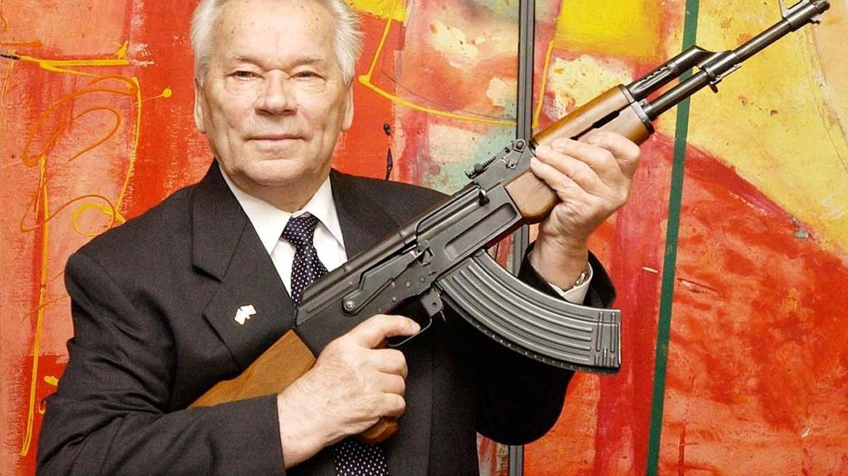 In this July 26, 2002 file photo, Russian weapon designer Mikhail Kalashnikov presents his legendary assault rifle to the media while opening the exhibition "Kalashnikov - legend and curse of a weapon" at a weapons museum in Suhl, Germany.