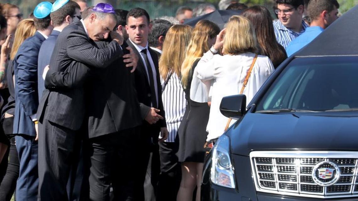 Mourners at the Star of David Memorial Gardens and Funeral Chapel are seen at the gravesite for shooting victim Meadow Pollack. She was one of 17 people killed at Marjory Stoneman Douglas High School on Wednesday, Feb. 14, 2018.