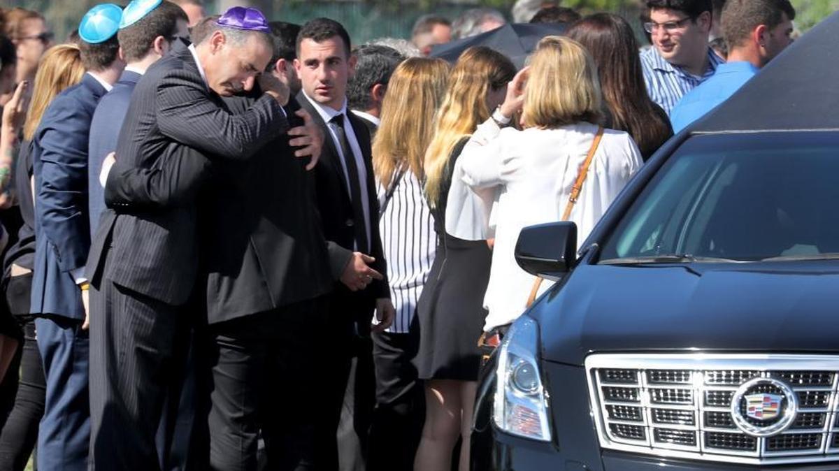 Mourners at the Star of David Memorial Gardens and Funeral Chapel are seen at the gravesite for shooting victim Meadow Pollack. She was one of 17 people killed at Marjory Stoneman Douglas High School on Wednesday, Feb. 14, 2018.