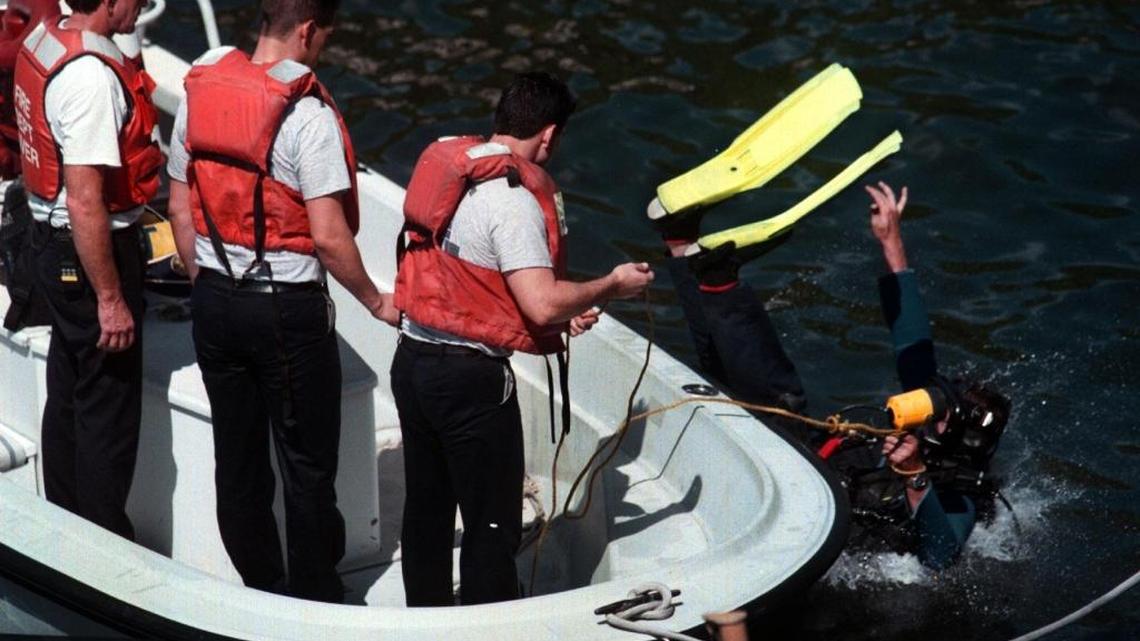 A diver goes overboard with a flashlight and tow rope as Fort Lauderdale Fire Rescue workers conduct a search in 1997. Crews are searching for a 50-year-old male diver who went missing at Copenhagen Reef Saturday.