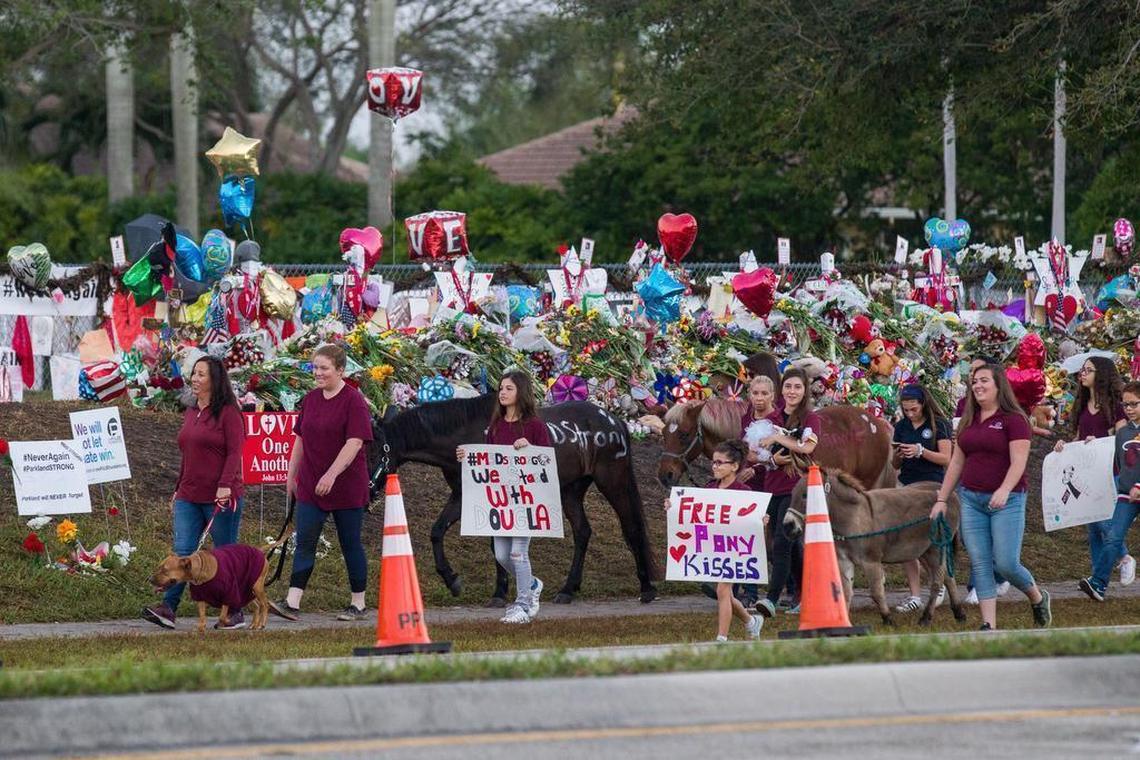 Supporters greet arriving students at Marjory Stoneman Douglas High with signs, dogs and ponies as teens head back to class for the first time since the Feb. 14 shootings.