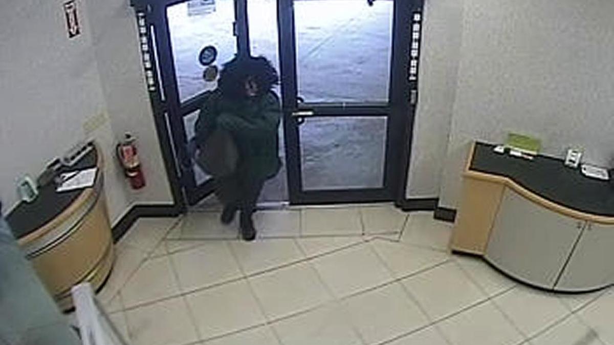A robber enters the First Bank Sunrise branch on Wednesday, Feb. 22, 2017.