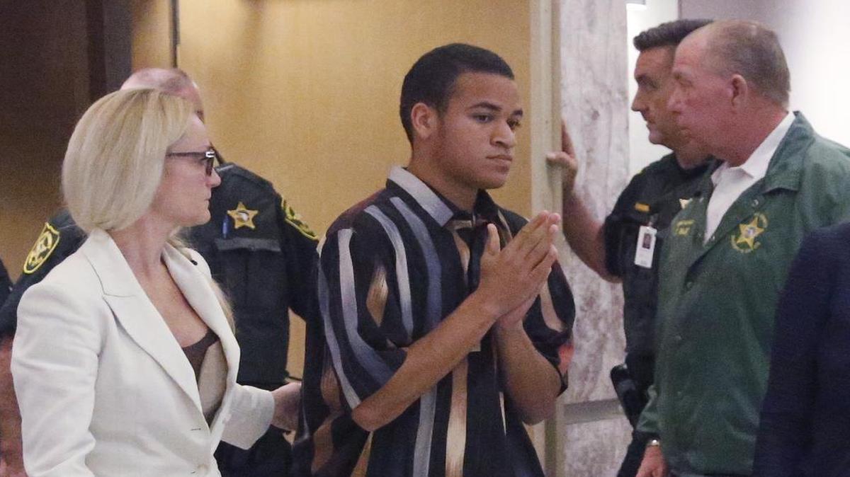 The brother of Nikolas Cruz, Zachary Cruz, center, leaves the courtroom after his brother's arraignment before Broward Circuit Judge Elizabeth Scherer, Wednesday, March 14, 2018, in Fort Lauderdale. The Broward Sheriff’s Office arrested Zachary Cruz Monday, March 19, 2018, and charged him with trespassing at Marjory Stoneman Douglas High School, the scene of last month’s mass shooting by his brother Nikolas.