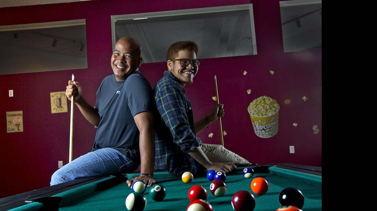 
Broward Sheriff's Deputy Sgt. Samuel Samaroo, left, donated a kidney to his 19-year-old son, Elijah, or E.J. The father and son hang out and play pool at their Coral Springs home.

