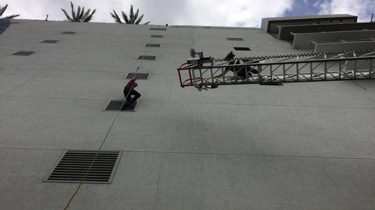 Hallandale Beach Fire Rescue retrieves mural painter suspended from fourth floor of Hyde Resort and Residences.