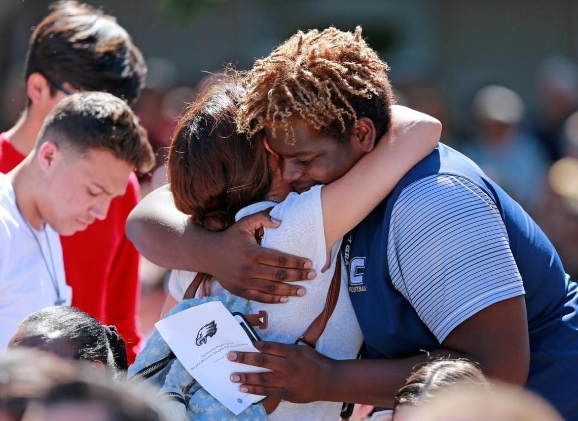 Attendees comfort each other at a community prayer vigil at Parkridge Church for shooting victims from Marjory Stoneman Douglas High School in Parkland.