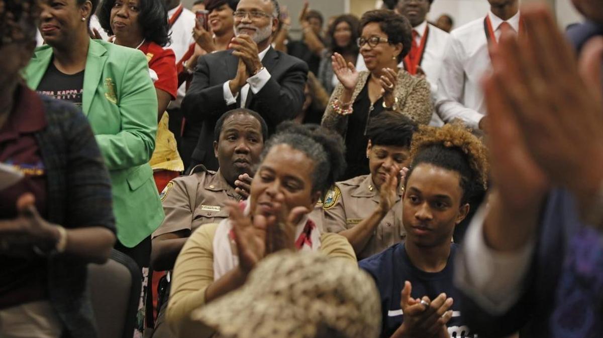 The audience reacts at a town hall on gun violence and school safety at Betty T. Ferguson Recreational Auditorium in Miami Gardens on Tuesday.