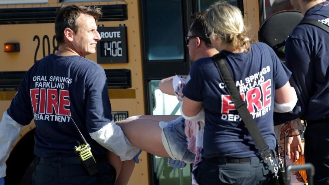 Medical personnel tend to a victim outside of Marjory Stoneman Douglas High School in Parkland after reports of an active shooter Wednesday, Feb. 14, 2018.
