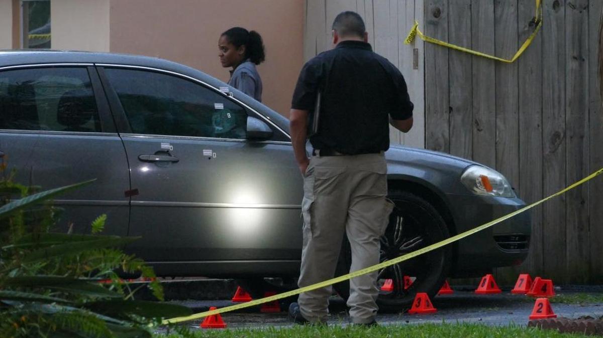 Investigators scour the scene where a father of three and the husband of an Opa-locka police officer was shot and killed outside of a Miramar home, Thursday October 29, 2015.