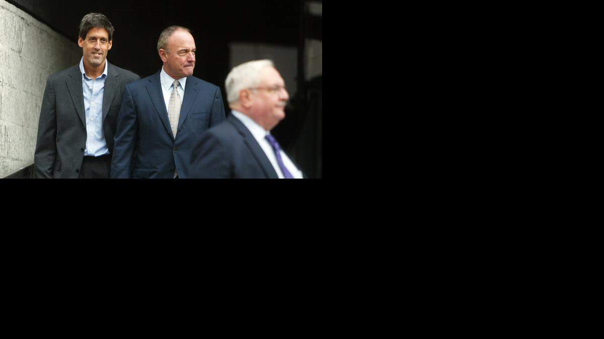 
Dr. Alan Mendelsohn, left, is a Hollywood ophthalmologist who has raised millions for Florida politicians. Here he exits federal court with his lawyers after his bond hearing in September 2009.

