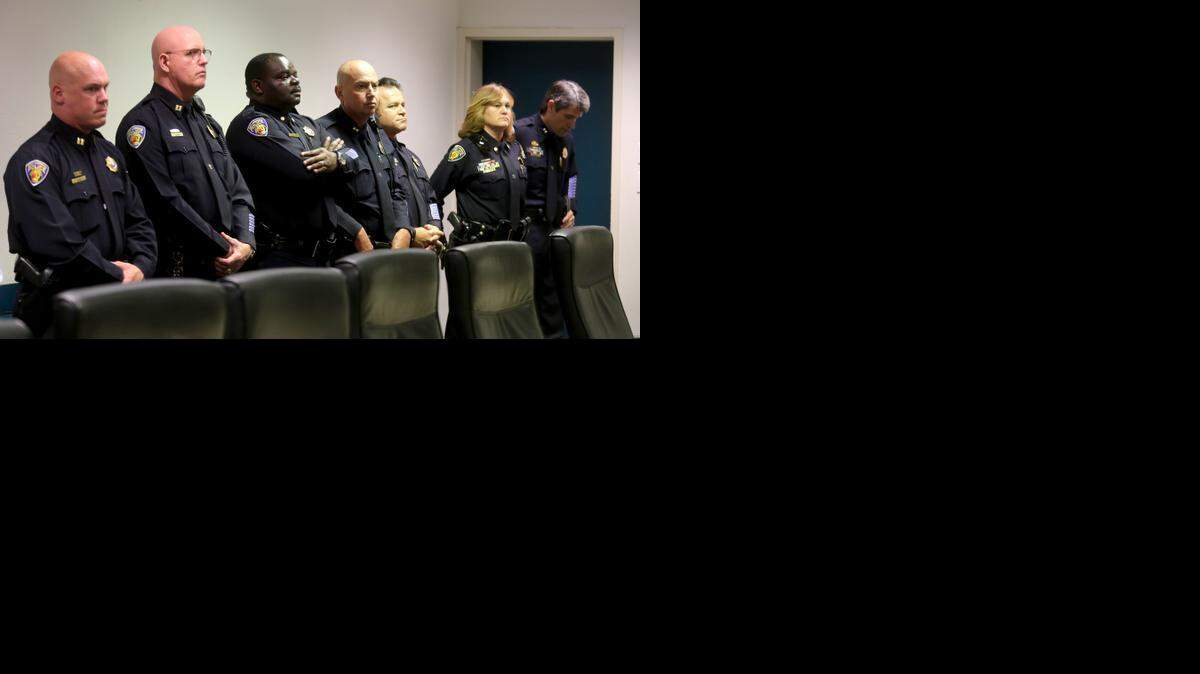 
Police officers listen to the press conference as Ft. Lauderdale Police Chief Frank Adderley talks to the media. Five months after an internal affairs investigation of four Fort Lauderdale Police officers began, city officials said Friday a late afternoon press conference will be held to discuss its conclusion. 
