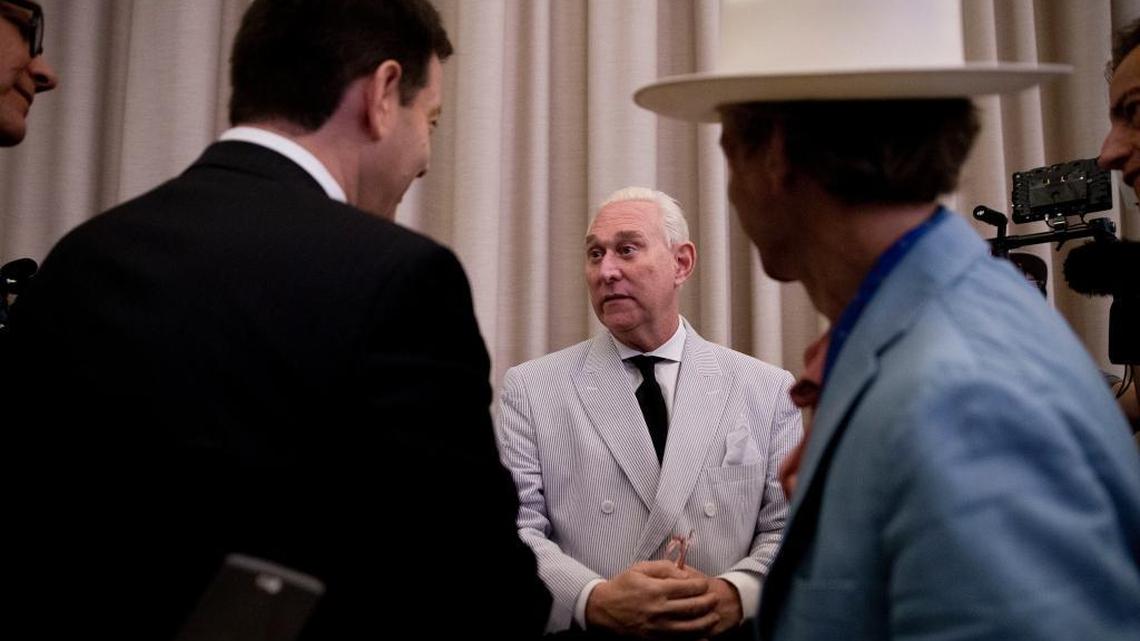 In this photo taken July 16, 2016, Roger Stone, an adviser to Donald Trump, center, speaks to reporters in New York. Stone says he believes his contacts with a Russian-linked hacker who took credit for breaching the Democratic National Committee were obtained through a FISA warrant, which allows the government to collect the communications of individuals suspected of being agents of a foreign power.