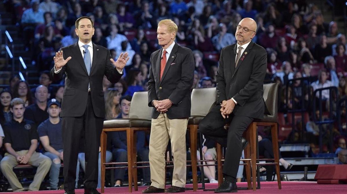 Senator Marco Rubio, left, explains his position during a CNN town hall meeting, Wednesday, Feb. 21, 2018, at the BB&T Center, in Sunrise, Florida.