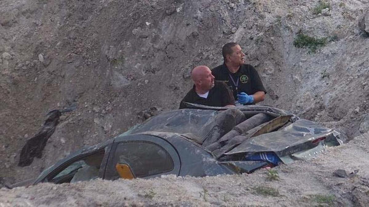 Investigators look over the crash site along northbound I-75 just north of Stirling Road.