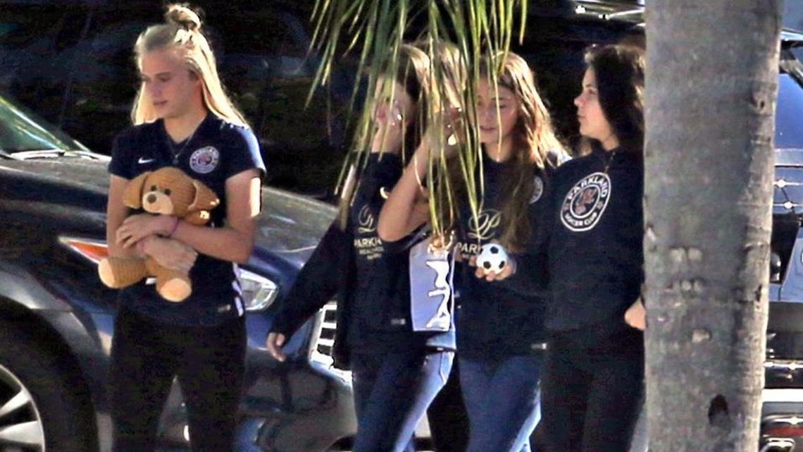 Students carrying a soccer ball and a teddy bear arrive at the Star of David Memorial Gardens Cemetery and Funeral Chapel in North Lauderdale for the funeral of Alyssa Alhadeff on Friday, Feb. 16, 2018. She was one of the 17 victims killed in the mass shooting at Marjory Stone Douglas High School on Wednesday, Feb. 14, 2018.