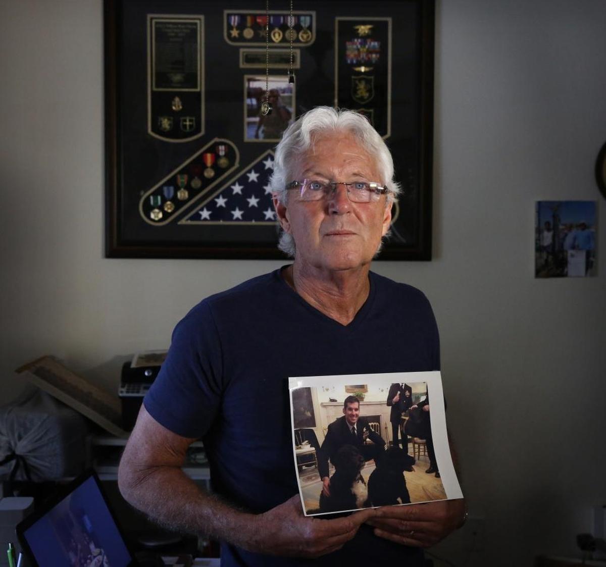 William ‘Bill’ Owen holds a photo of son Ryan, the first military death of the Trump administration.