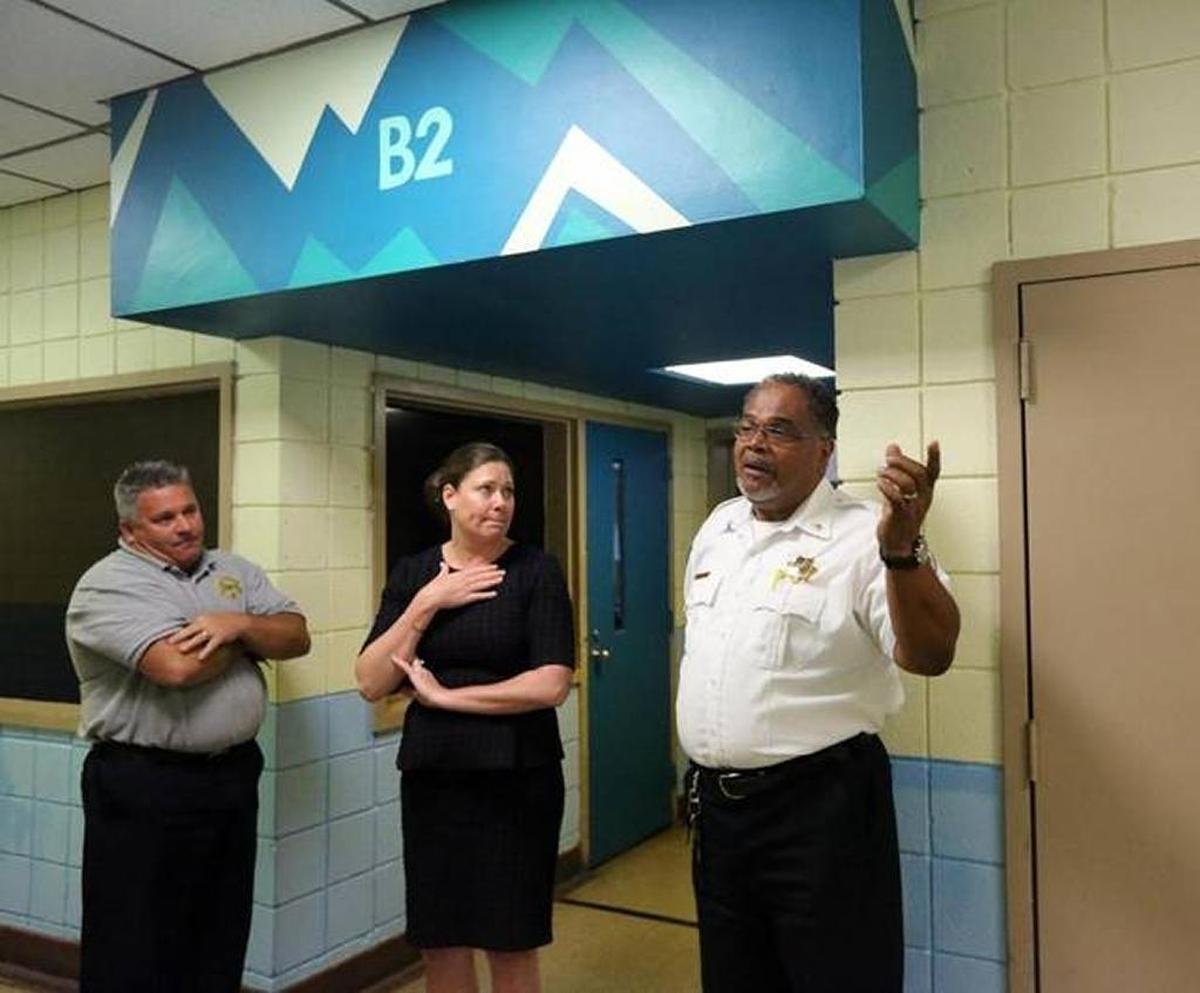 Vincent Vurro, acting chief of the Department of Juvenile Justice’s South Region Detention Services, and DJJ Secretary Christy Daly listen to Jonathan Hackley, superintendent of the Broward Regional Juvenile Detention Center, speak over the screaming of a detainee. The agency did not identify him, but the Herald learned his identity independently: 17-year-old Keishan Ross.