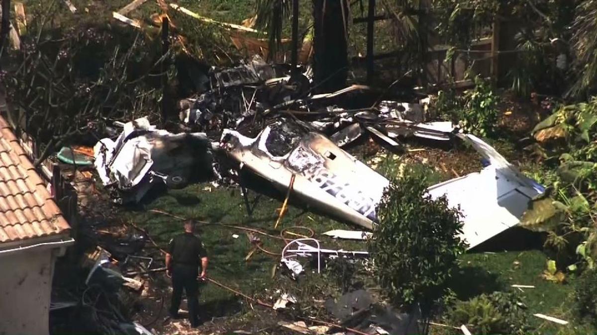 A single-engine prop plane is shown Monday after it crashed into at least one home shortly after takeoff from Pompano Beach Airpark.