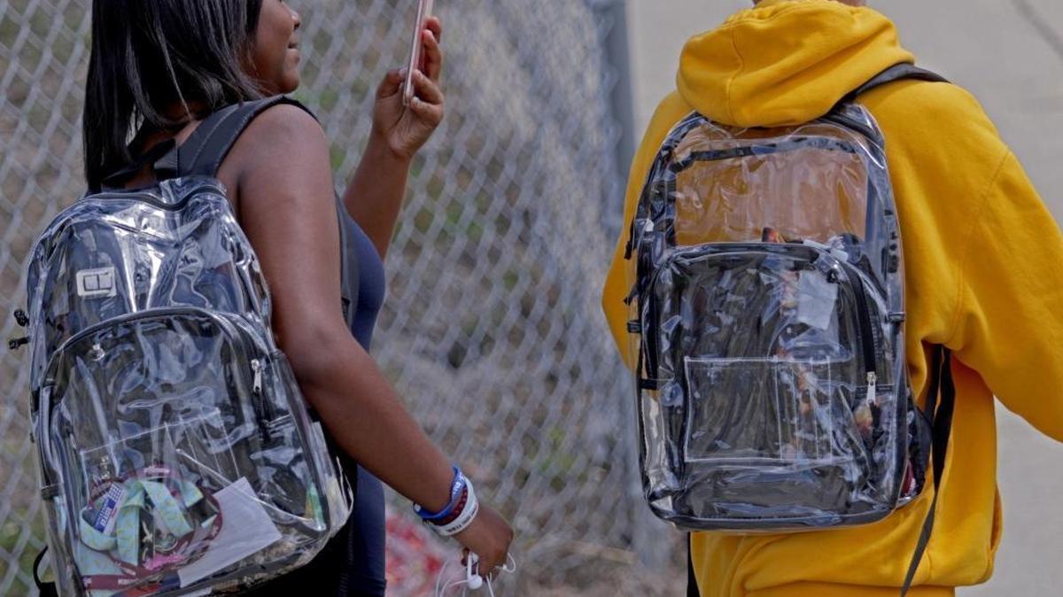 Students wear clear backpacks outside of Marjory Stoneman Douglas High School in Parkland, Florida, on Monday, April 2, 2018. The bags are one of a number of security measures the school district enacted as a result of the Feb. 14 , 2018, shooting at the school that killed 17 students and faculty members.