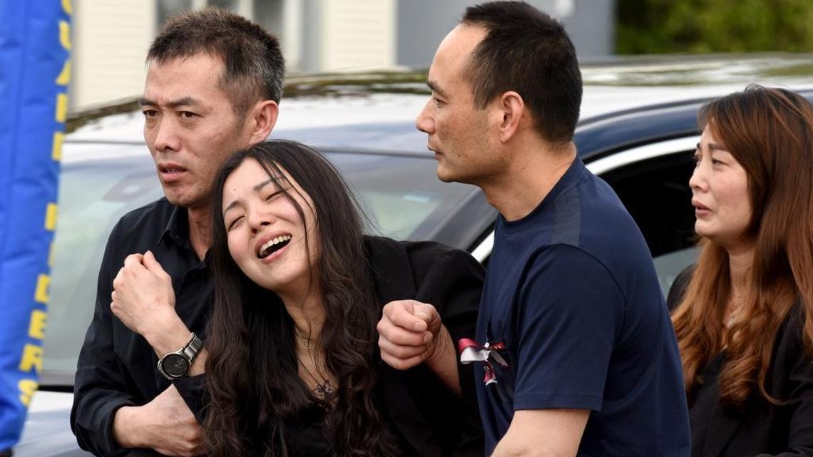 Peter Wang's mother, Hui, cries as she is helped into a waiting car with her family after the memorial service for her 15-year-old son at Kraeer Funeral Home in Coral Springs.