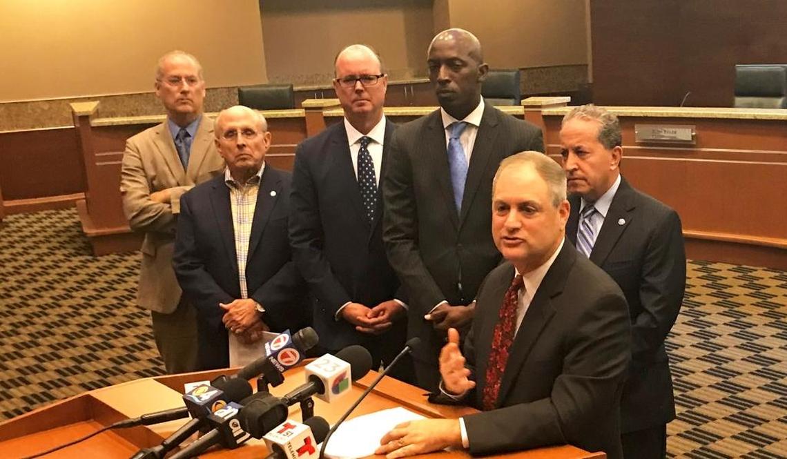 Jamie Cole, city attorney for Weston, addresses reporters during a City Hall press conference on April 2, 2018, about a lawsuit filed by 10 South Florida cities against Gov. Rick Scott and other state officials over a 2011 state law that established stiff penalties for enacting municipal gun regulations. Waiting their turns to speak, from left to right, are five named plaintiffs in the litigation: Miami Beach Mayor Dan Gelber, Coral Gables Mayor Raúl Valdés-Fauli, Pompano Beach Mayor Lamar Fisher, Miramar Mayor Wayne Messam and Weston Mayor Daniel Stermer.