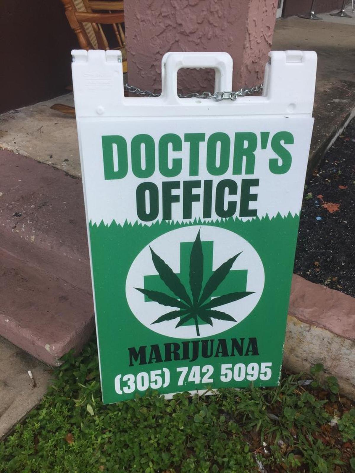 A sign chained to a concrete post at a two-story strip mall off Southwest Eighth Street directs patients to 420 Miami Doctor. The company lists an office upstairs, but the space is empty.