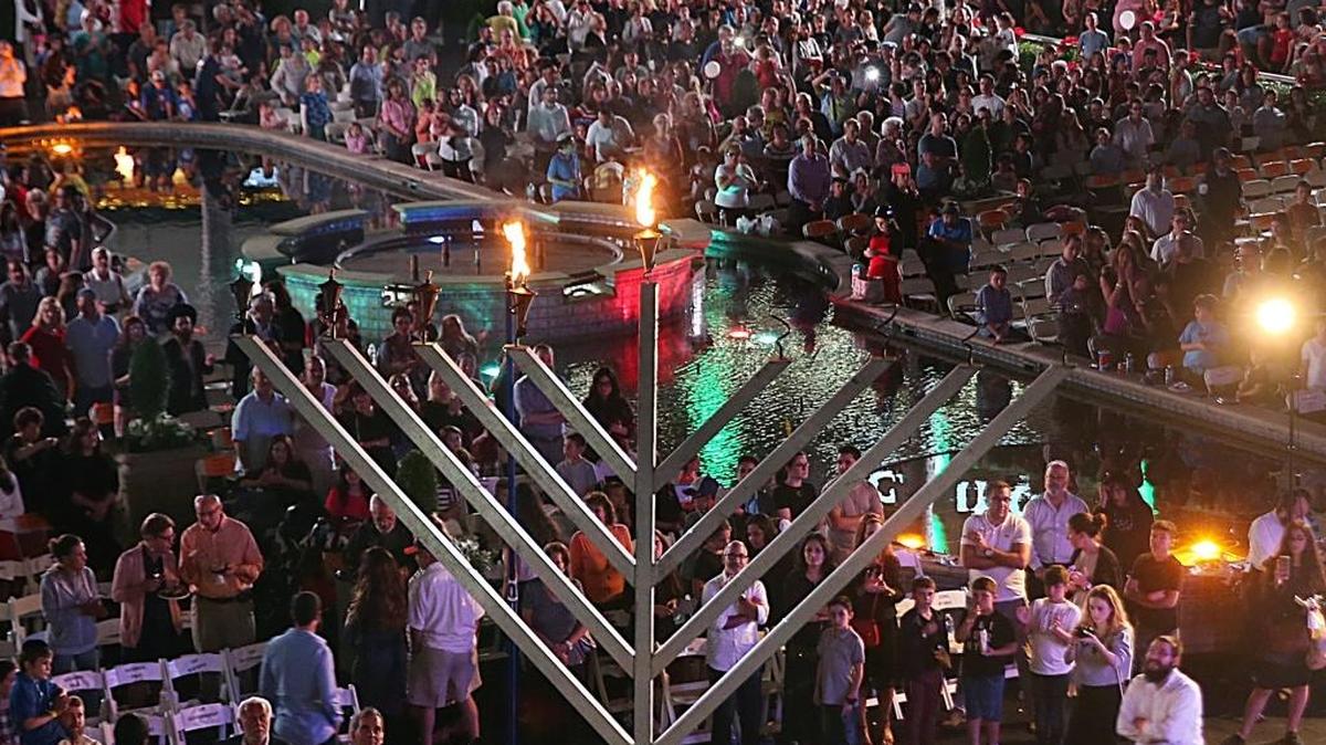 Guests look up as the Menorah is lit during the celebration of the 37th annual South Florida Chassidic Chanukah Festival, presented by Friendship Circle of Chabad of South Broward at Gulfstream Park in Hallandale Beach on Tuesday.