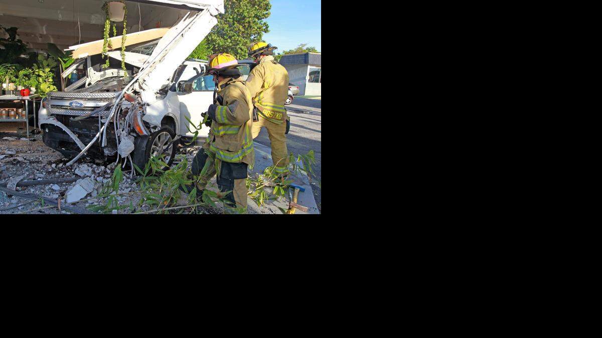 
Firefighters Rosie Massarelli and Kris Boszko respond to a car that crashed into a building on Federal Highway in Fort Lauderdale, September 8, 2014.


