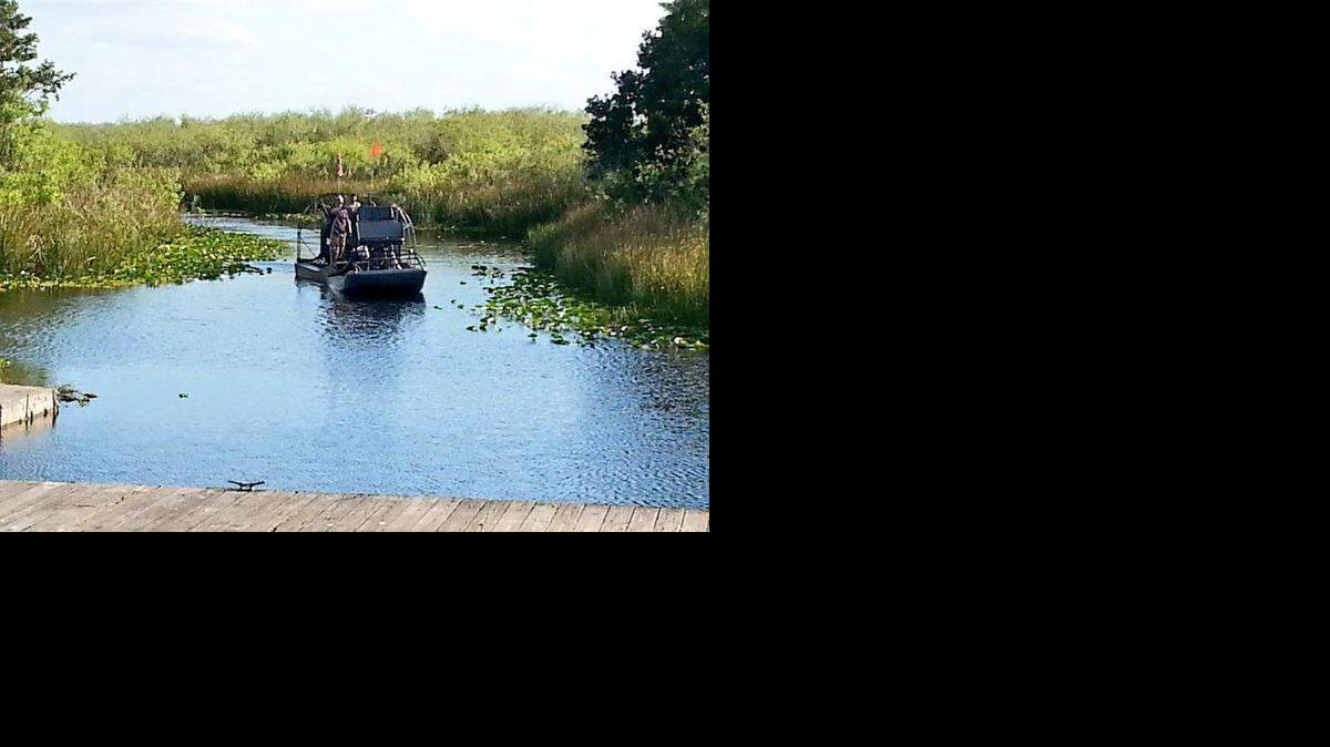 
A private airboat is towed back to shore in the Everglades after colliding with a Florida Fish and Wildlife Commission airboat. One woman from each boat was injured.
