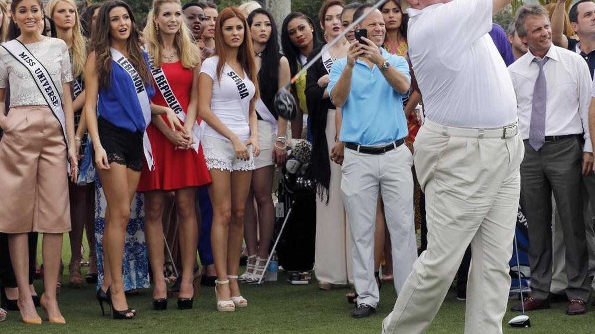 Donald Trump tees off at his Doral resort, with Miss Universe contestants as an audience, in 2015.