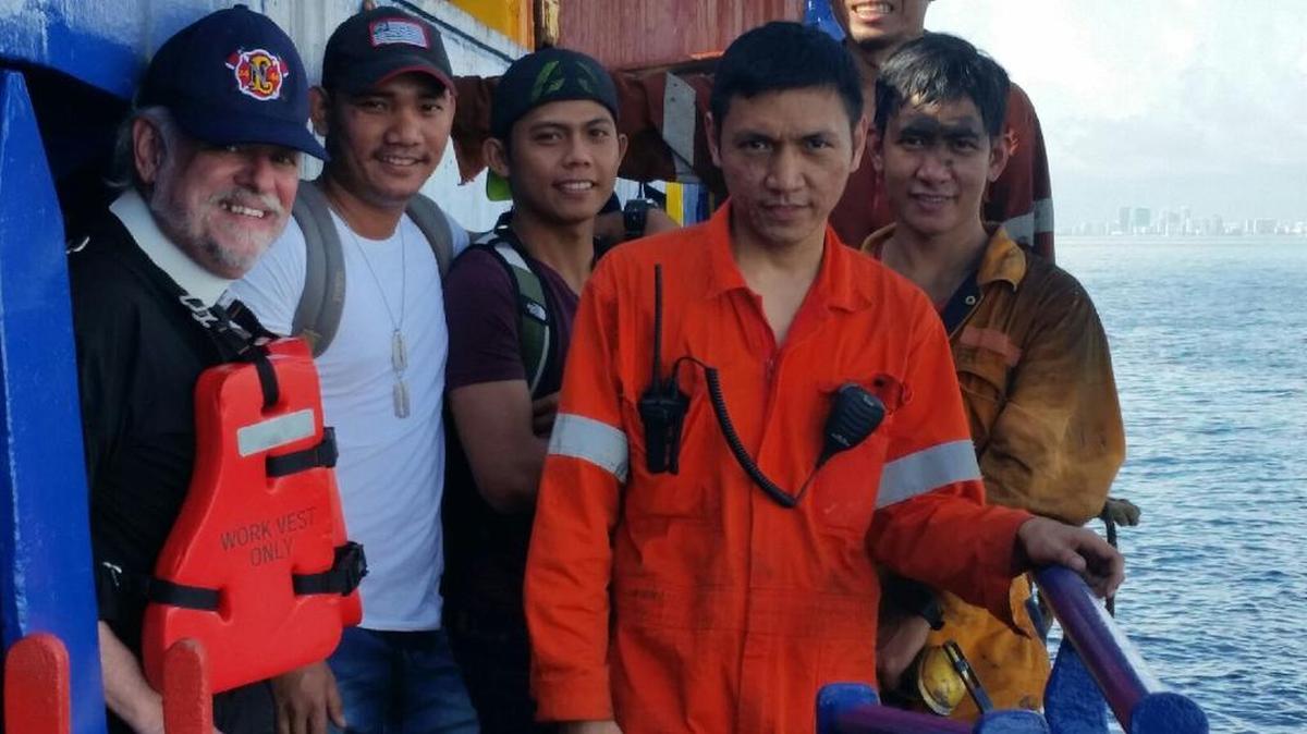 The 11-member crew of the Delphinus is caught in a web of maritime and immigration law leaving them stuck on their ship, a mile offshore near Port Everglades.