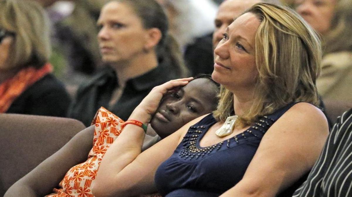 Amy Riddering comforts adopted daughter Biba, 15, during memorial service for Amy's husband, Michael James Riddering at Hollywood Community Church. The former Cooper City man was serving as missionary in Burkina Faso when he was killed by terrorists on Jan. 15.