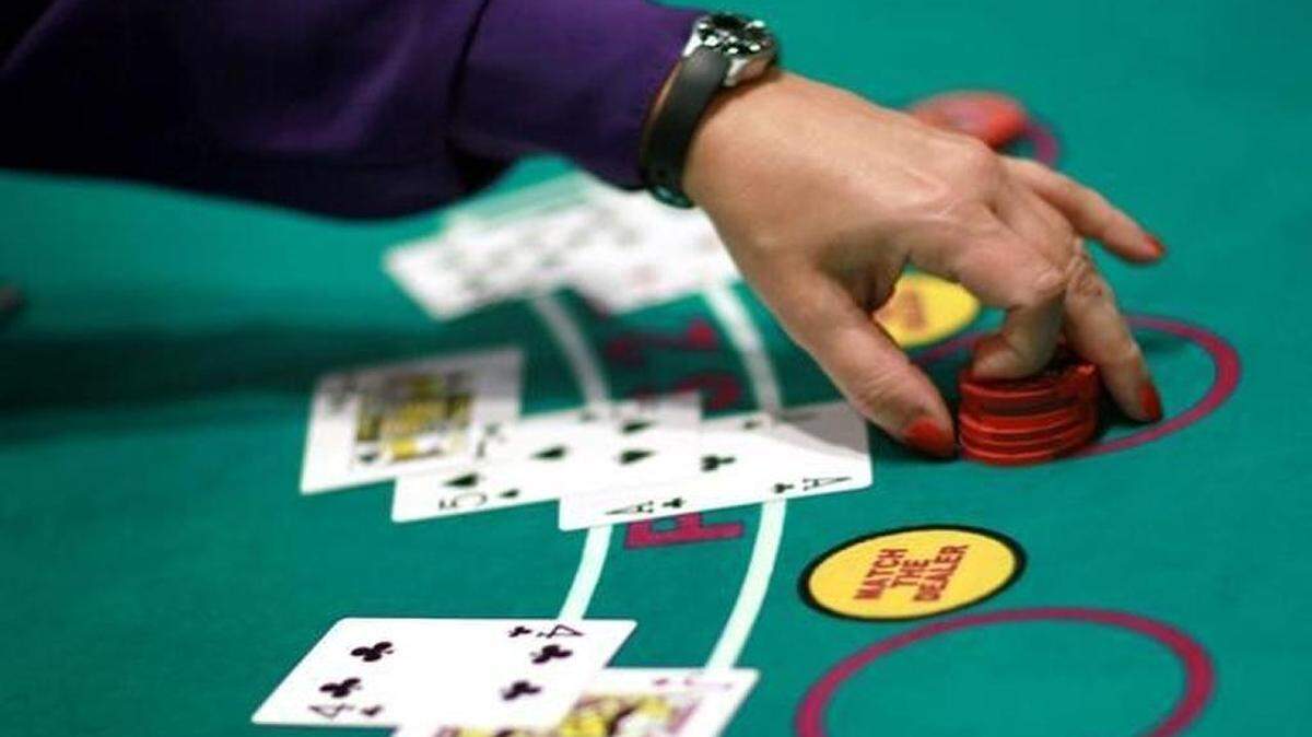 A dealer works the blackjack table during the grand opening of the newest building at the Seminole Casino Coconut Creek on December 17, 2010.