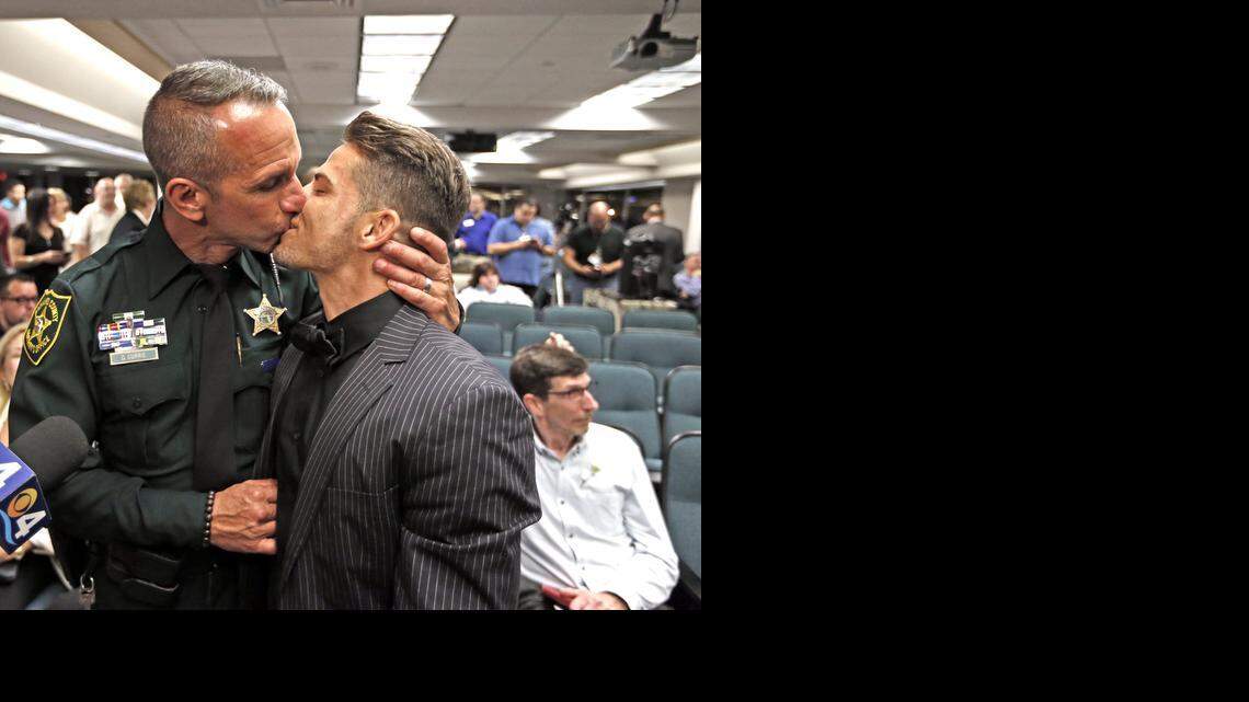 
Broward Sheriff’s Office officer David Currie and Aaron Woodard kiss after a mass wedding at the Broward County Courthouse in Fort Lauderdale.
